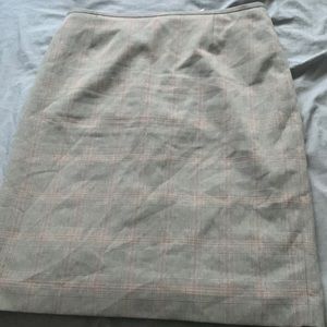 This is a size 8 skirt that is gray with red and black plaid color